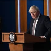 LONDON, ENGLAND - NOVEMBER 15: Prime Minister Boris Johnson standing next to British Chief Medical Officer for England Chris Whitty as he addresses the media regarding the United Kingdom's Covid-19 infection rate and vaccination campaign at Downing Street Briefing Room on November 15, 2021 in London, England. The prime minister and his advisers encouraged Britons to receive their Covid-19 vaccine booster when eligible. (Photo by Leon Neal - WPA Pool/Getty Images)