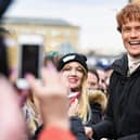 Sam Heughan meets fans who were waiting in St Andrew’s Square on March 14, 2018 in Glasgow,Scotland. (Photo by Jeff J Mitchell/Getty Images)