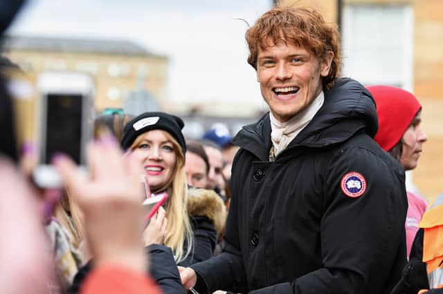Sam Heughan meets fans who were waiting in St Andrew’s Square on March 14, 2018 in Glasgow,Scotland. (Photo by Jeff J Mitchell/Getty Images)
