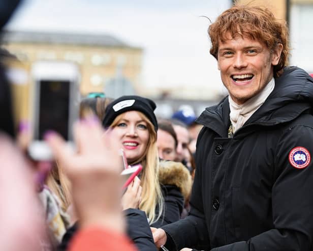 Sam Heughan meets fans who were waiting in St Andrew’s Square on March 14, 2018 in Glasgow,Scotland. (Photo by Jeff J Mitchell/Getty Images)