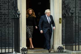 Prime Minister Boris Johnson and his partner Carrie Symonds stand outside the door of number 10 Downing Street (Photo by Leon Neal/Getty Images)