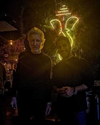 Ajay Kumar with Pink Floyd frontman, Roger Waters, inside the Merchant City restaurant in Glasgow, Swadish.