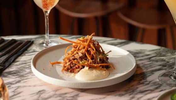 The Thai Beef Tartare served with pickled lime gel, crispy shallots and cured egg yolk shavings