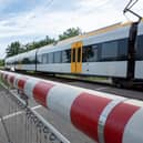A CCTV clip has shown the heart-stopping moment a woman has a near miss with a train on a level crossing