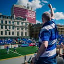 A fan cheers on his favourite team from the stand in Glasgow