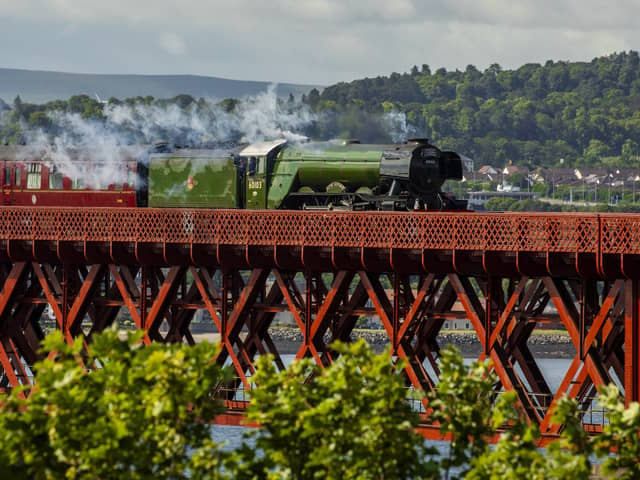 Flying Scotsman passes over the Forth Bridge as part of a series of events to celebrate her centenary. The world famous steam locomotive left Edinburgh before heading north to Aberdeen. 