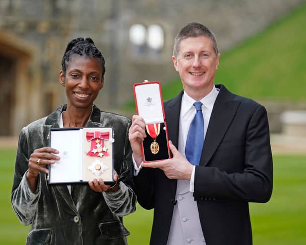 Sharon White poses with her award after she was made a Dame CBE, for public service, next to her husband Sir Robert Chote (Photo by Andrew Matthews - WPA Pool/Getty Images)