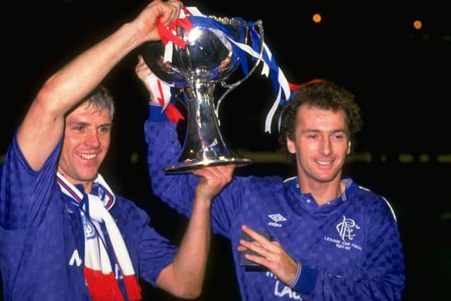 Graham Roberts (left) and Trevor Francis (right) both of Rangers  hold the trophy aloft after their victory in the Skol Cup Final against Aberdeen in 1988