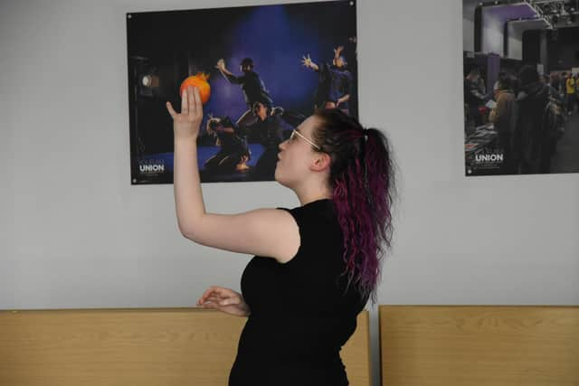 Lost in Translation actor Ellie McKay holding a pomegranate - a prop that is central to the play and representative of Iranian/Western diaspora and identity in the Eastern world.