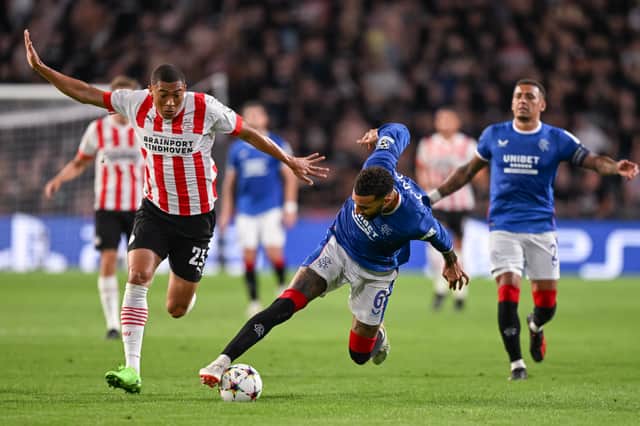 Connor Goldson of Glasgow Rangers is tackled by Joey Veerman of PSV Eindhoven
