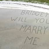 The view the couple got from their flight before landing on the beach - written in the sand the proposal reads:”Bridget will you marry me"