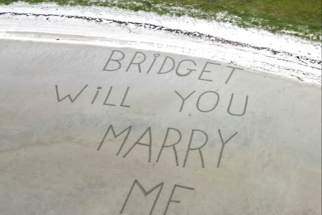 The view the couple got from their flight before landing on the beach - written in the sand the proposal reads:”Bridget will you marry me"