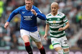 John Lundstram of Rangers evades Daizen Maeda of Celtic