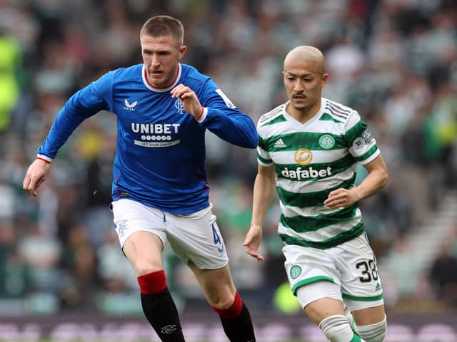 John Lundstram of Rangers evades Daizen Maeda of Celtic