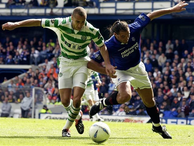  Henrik Larsson of Celtic is tackled by Lorenzo Amoruso of Rangers during the Bank of Scotland Scottish Premier League match between Glasgow Rangers and Glasgow Celtic held on April 27, 2003 at the Ibrox Stadium