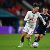 England's midfielder Jack Grealish (L) and Scotland's defender Kieran Tierney vie for the ball 