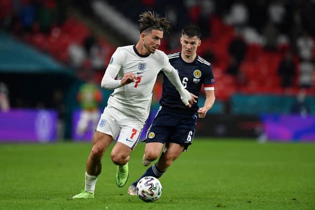 England's midfielder Jack Grealish (L) and Scotland's defender Kieran Tierney vie for the ball