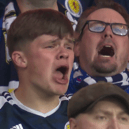 Scotland fans sing the Flower of Scotland before the England game. 