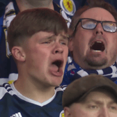 Scotland fans sing the Flower of Scotland before the England game. 