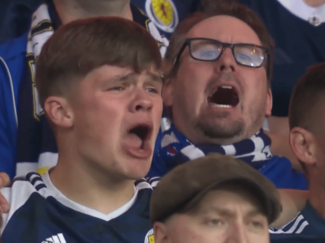 Scotland fans sing the Flower of Scotland before the England game. 