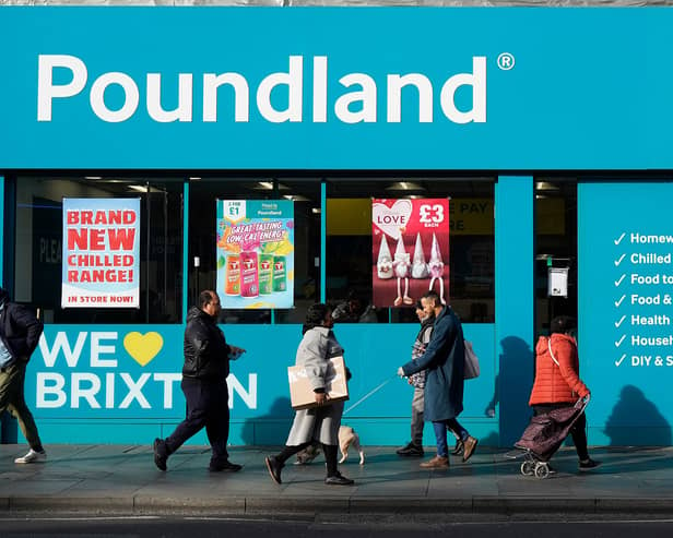 Shoppers walk past a Poundland shop in Brixton, south London.