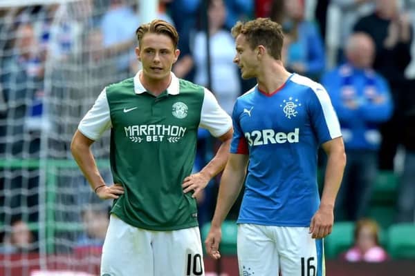 Scott Allan of Hibs talks to Andy Halliday of Rangers during a match at Easter Road