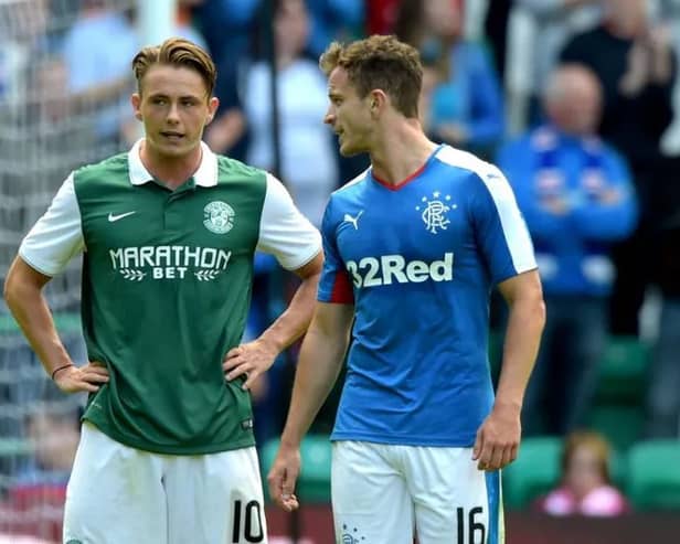 Scott Allan of Hibs talks to Andy Halliday of Rangers during a match at Easter Road