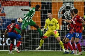 Aris Limassol defender Alex Moucketou-Moussounda (C) heads the ball beyond Rangers goalkeeper Jack Butland