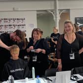 The team from ROAR Glasgow dressing a model’s hair backstage at Paris Fashion Week