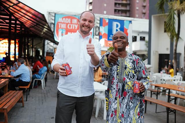 Pim-Pam creative director Luke McCarthy (left) and artist Lemi Ghariokwu pose with a can of Shakara