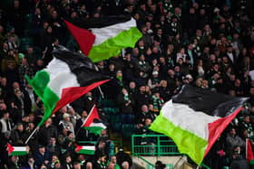 Celtic supporters hold Palestinian flags