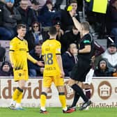 James Penrice of Livingston receives his team's first yellow card