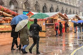 People walk across a Christmas market in downtown Milan - downtown Hamilton will see its own Christmas Markets when the Winter Village arrives at the Hamilton Accies stadium.