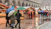 People walk across a Christmas market in downtown Milan - downtown Hamilton will see its own Christmas Markets when the Winter Village arrives at the Hamilton Accies stadium.
