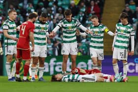 Kyogo Furuhashi of Celtic lies injured during the Cinch Scottish Premiership match between Celtic and Aberdeen