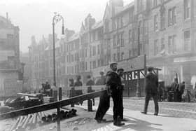 Workers take a brief rest on High Street - note the ornate lamppost and wooden street structures