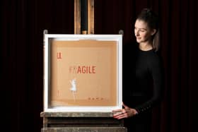 Auctioneer Amy Cameron with Banksy' screenprint 'Agile'