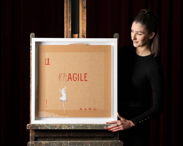 Auctioneer Amy Cameron with Banksy' screenprint 'Agile'
