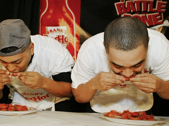 Michael Walker (L) and Meibaka Yohannes eat chicken wings during a preliminary round of the second annual "Battle to the Bone"  Buffalo Wings eating contest held at Madison Square Garden January 22, 2004 in New York City. The winner of the competition, Arnie "Chowhound" Chapman, consumed more than 100 wings in eight minutes. Incredible stuff.