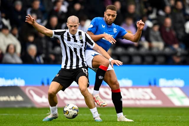 St Mirren's Alex Gogic (L) and Rangers' Cyriel Dessers in action 