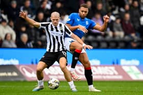 St Mirren's Alex Gogic (L) and Rangers' Cyriel Dessers in action 