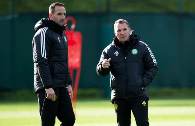 Brendan Rodgers speaks to Celtic assistant manager John Kennedy during a training session at Lennoxtown