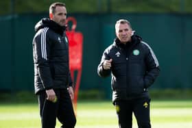 Brendan Rodgers speaks to Celtic assistant manager John Kennedy during a training session at Lennoxtown