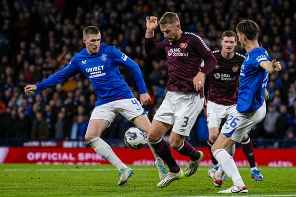 Rangers' Ben Davies fouls Hearts' Stephen Kingsley which results in a penalty for Hearts during the Viaplay Cup semi-final at Hampden Park.