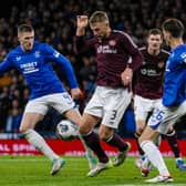 Rangers' Ben Davies fouls Hearts' Stephen Kingsley which results in a penalty for Hearts during the Viaplay Cup semi-final at Hampden Park.