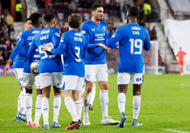 Abdallah Sima (R) is congratulated by his Rangers team mates after scoring against Hearts at Tynecastle.