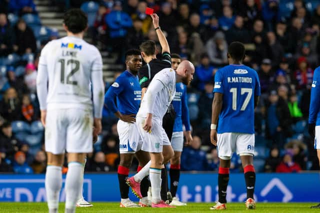 Referee Kevin Clancy upgrades Rangers' Jose Cifuentes' yellow card to a red card after a VAR check for his challenge on Dundee's Amadou Bakayoko 