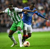 Real Betis striker Liuz Henrique (L) fights for the ball with Rangers midfielder Rabbi Matondo at Ibrox.