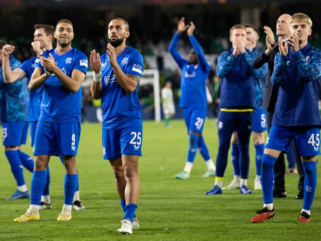 Kemar Roofe leads the Rangers squad in applauding the travelling fans at full time in Seville. 