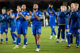 Kemar Roofe leads the Rangers squad in applauding the travelling fans at full time in Seville. 